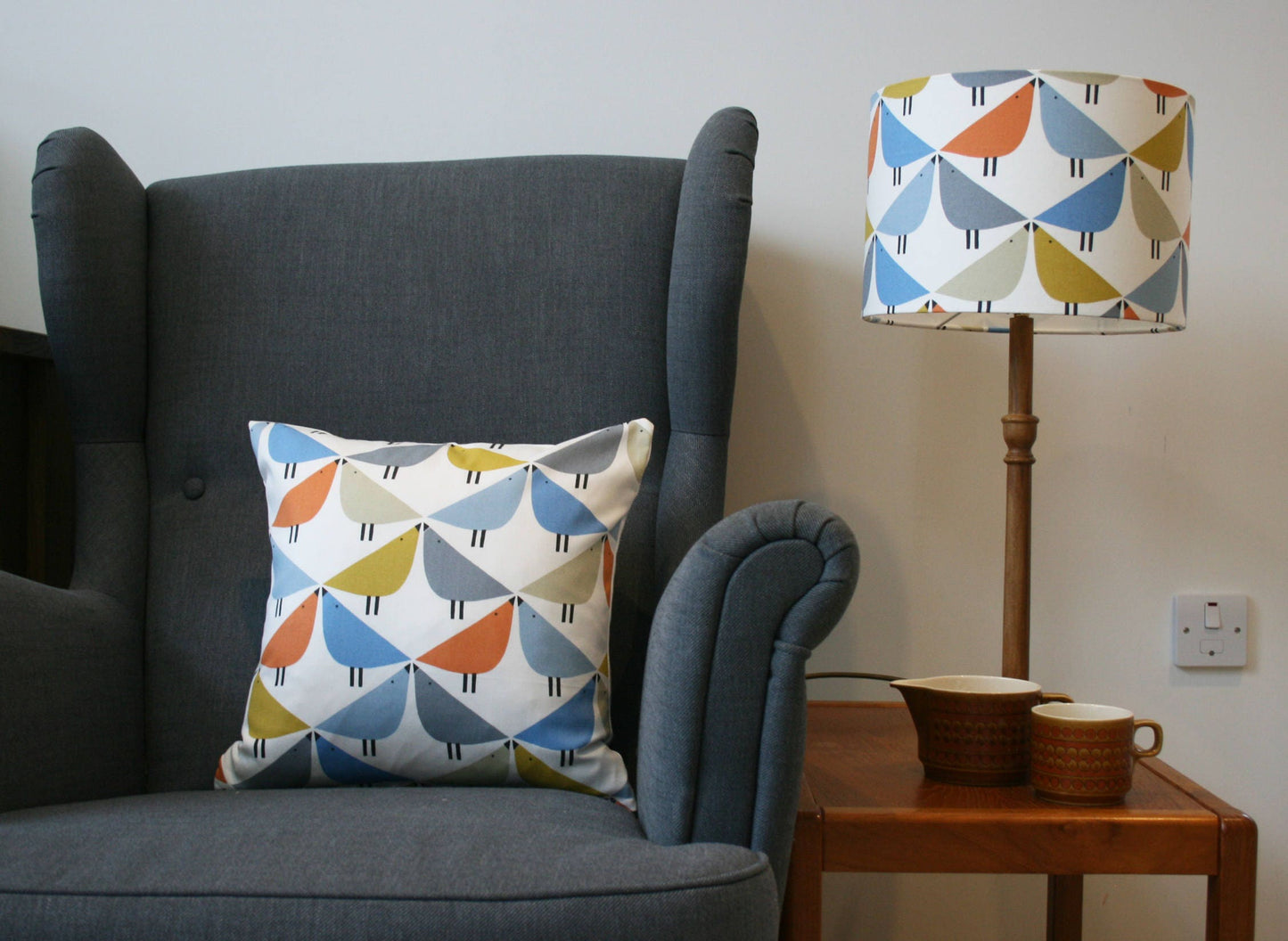 Love bird print cushion in orange, blue and grey